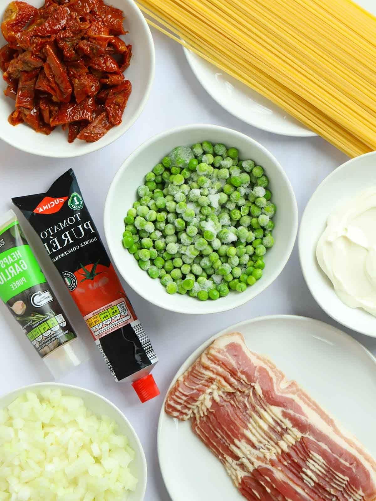 Gli ingredienti per la ricetta della Pasta con Pancetta disposti su un piano di lavoro.