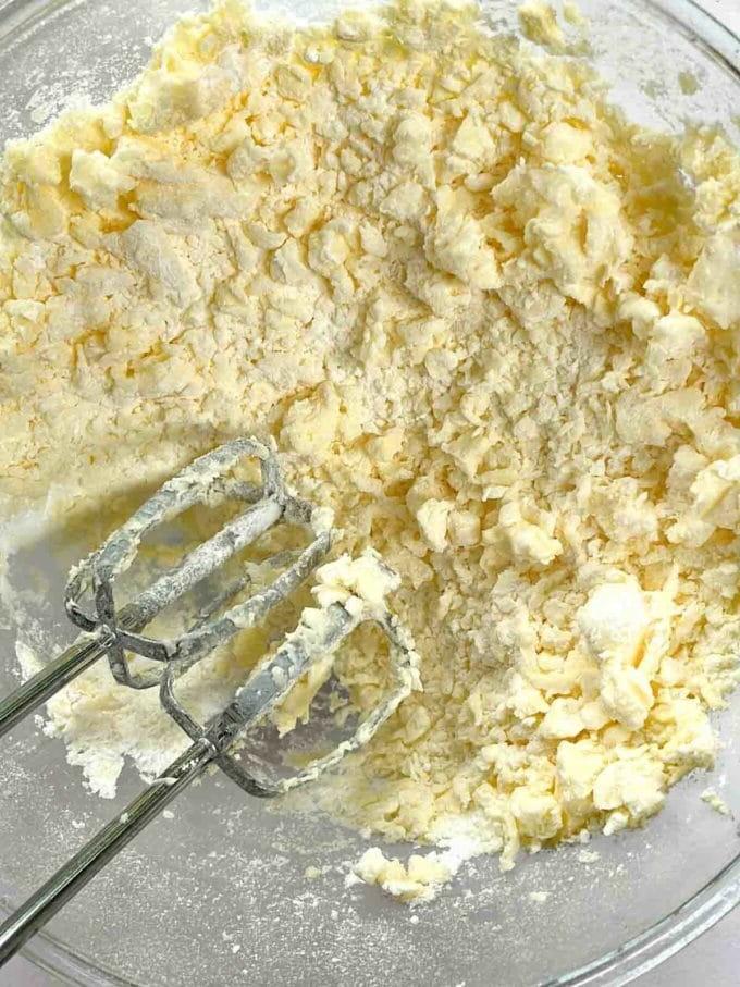 Glassa al Formaggio Cremoso {per Torte e Dolci al Forno} 5 Burro e zucchero a velo montati insieme in una ciotola di vetro per la ricetta della Glassa al Formaggio Cremoso.