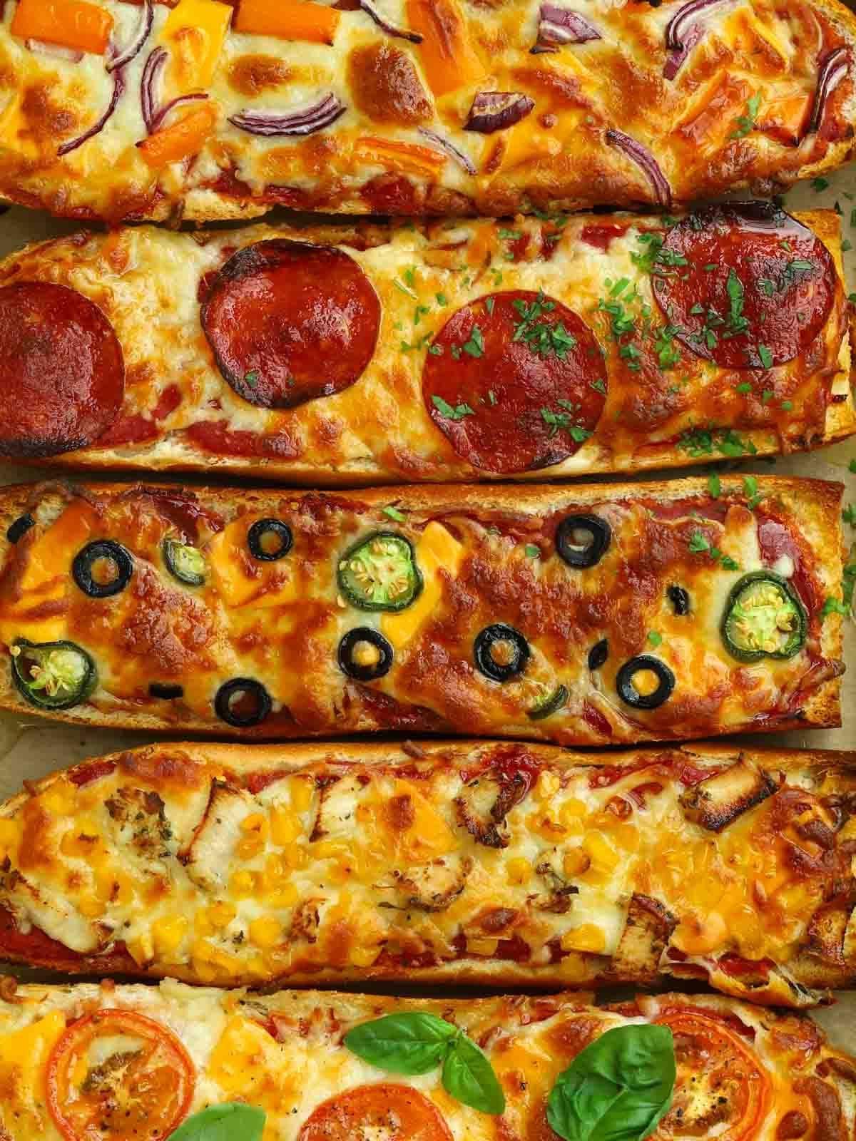 Pizza di Pane Francese 2 Pizze di Pane Francese cotte con una varietà di condimenti e pronte da mangiare.