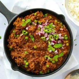 Piano Pasti Settimanale 2 5 Una grande pentola piena di curry keema di carne macinata di manzo con piselli e peperoncini.