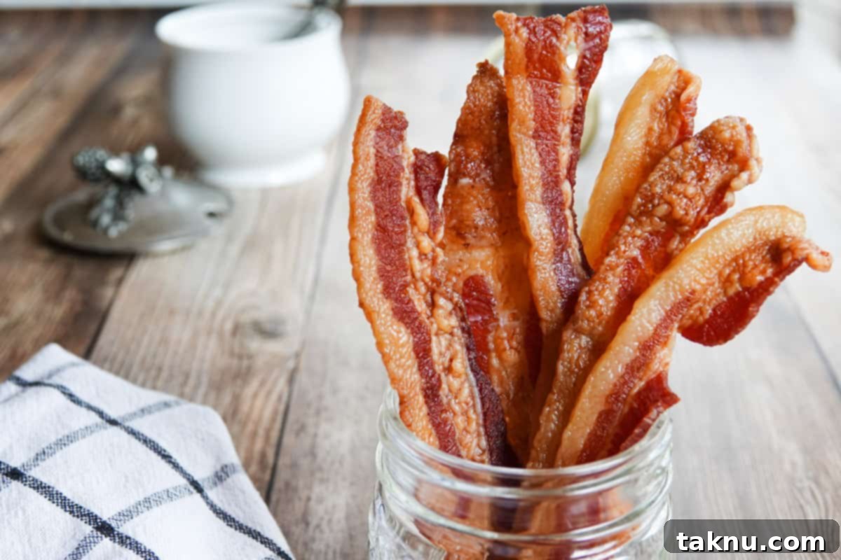 bacon jerky in glass jar with sugar cup in background