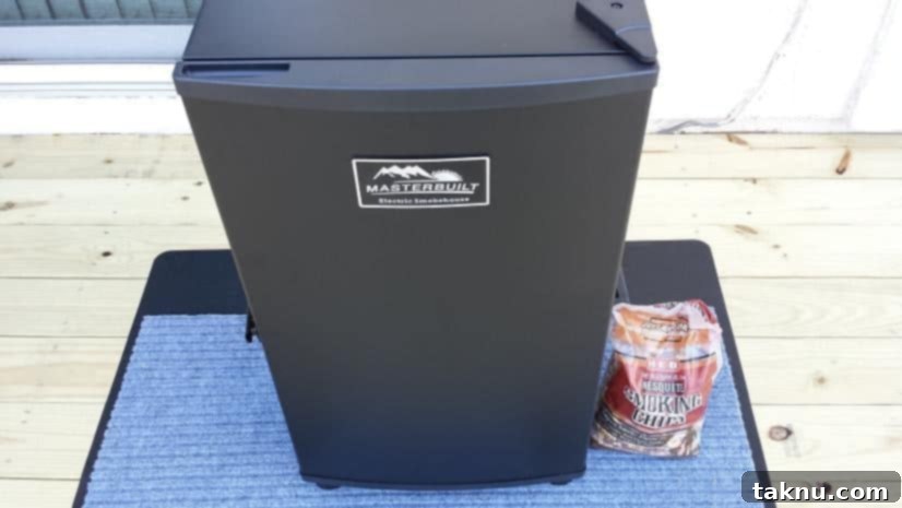 A dehydrator with wood chips, preparing for smoking jerky.