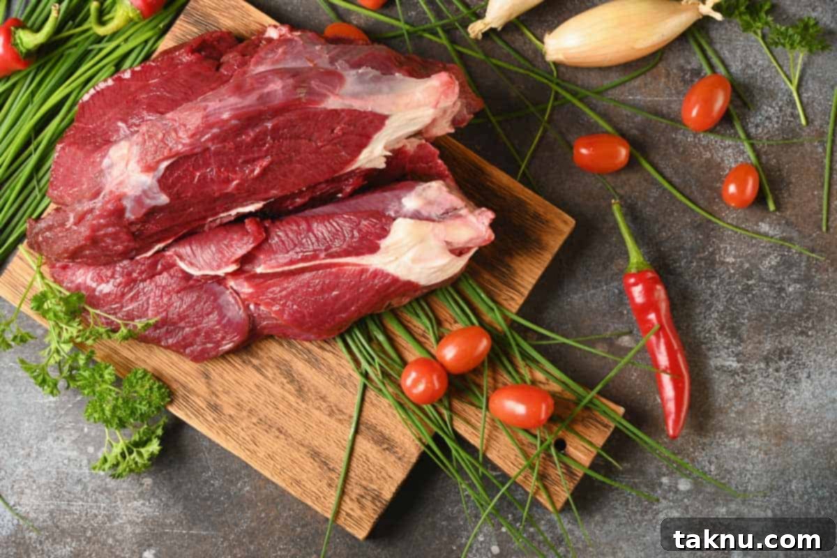 Elk Meat on cutting board with spices, highlighting its lean and mild characteristics for jerky