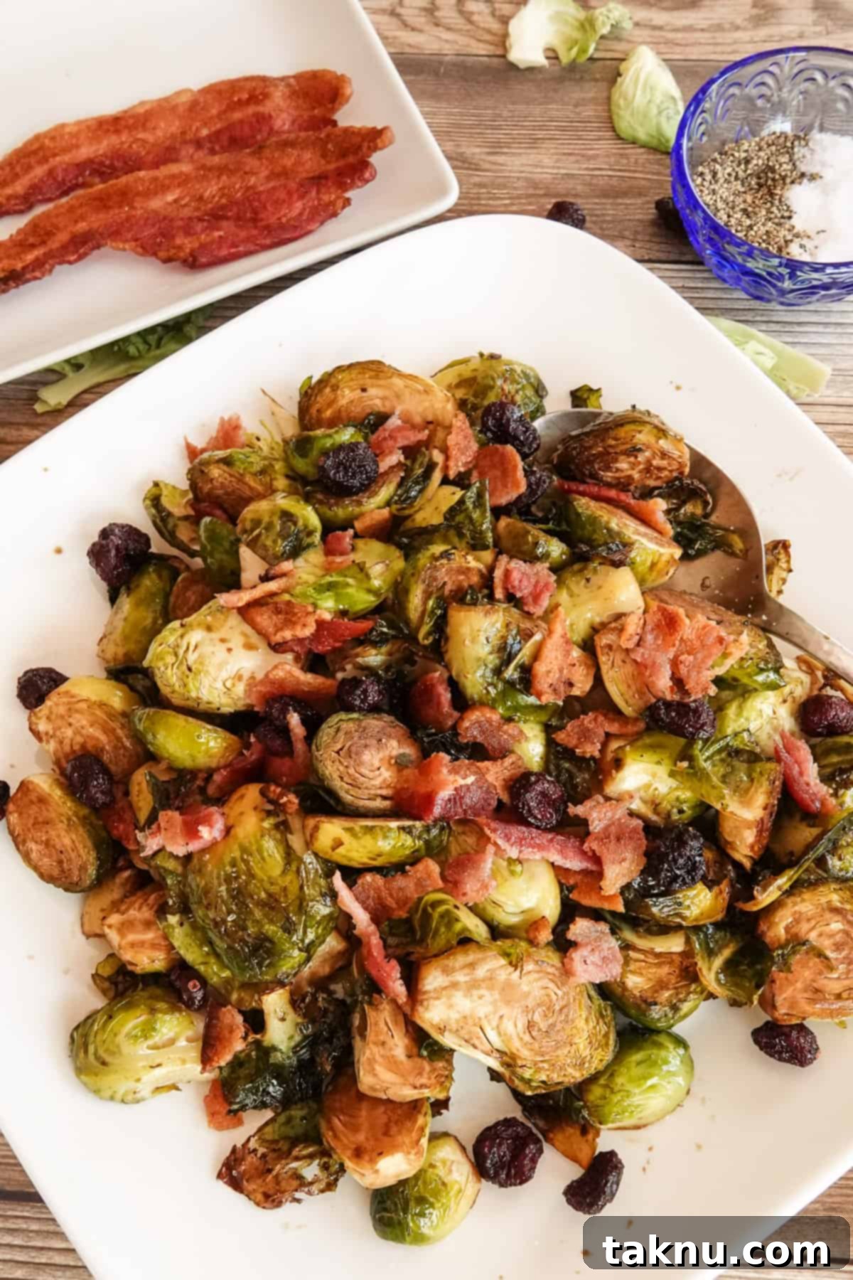 Brussel sprouts on plate with bacon and seasoning around