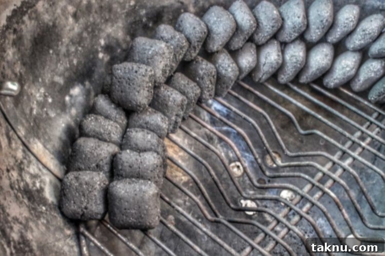 charcoal lined up along the inside of a charcoal grill