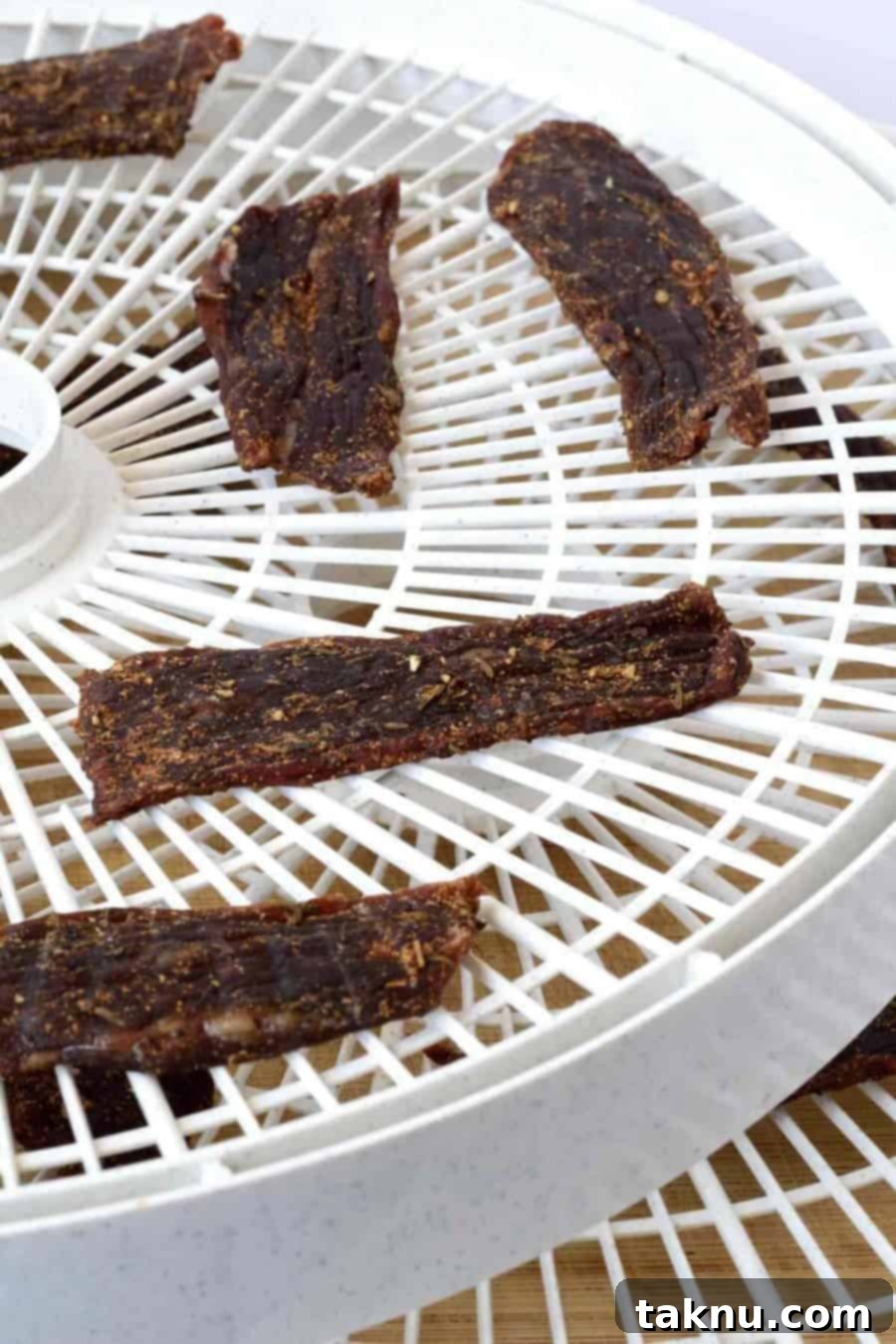 Finished Jamaican Jerk Beef Jerky strips, perfectly dried and ready to eat, displayed appetizingly