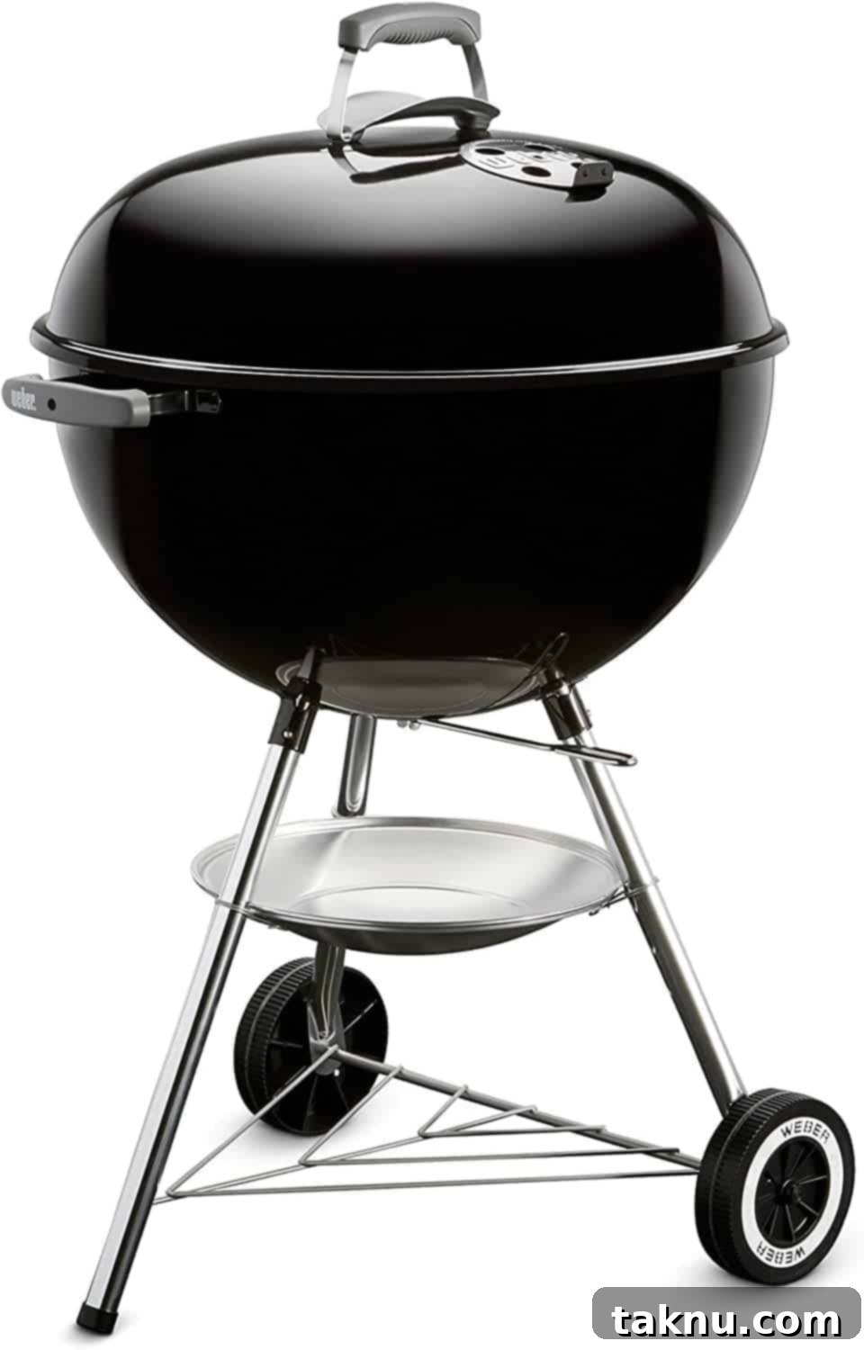 A classic charcoal grill with its lid securely on, indicating a steady cooking process.