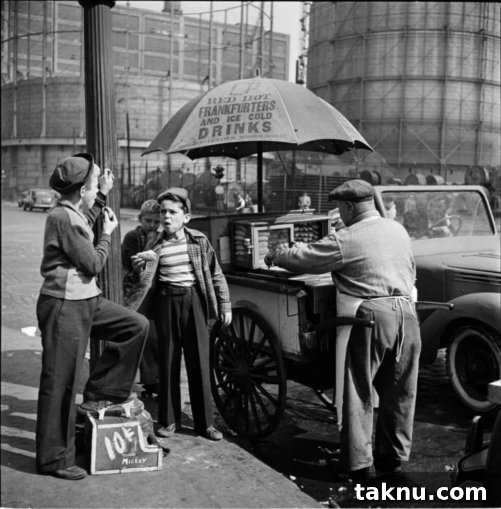 Two boys happily enjoying hot dogs from a street cart in bustling New York City during the 1920s, capturing a slice of history.