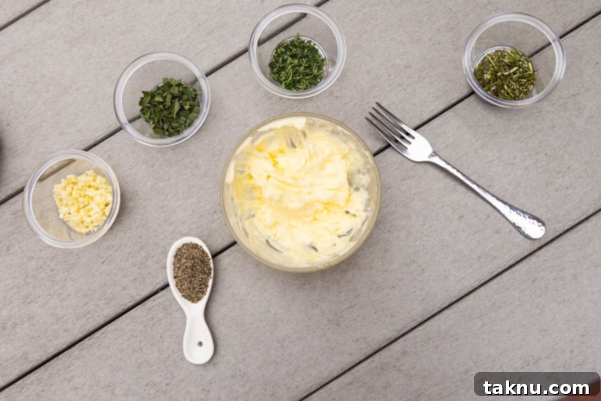 Crispy Skinned Smoked Turkey Masterpiece 5 Close-up of turkey seasoning ingredients, including softened butter, minced garlic, fresh rosemary, thyme, and black pepper, ready to be mixed on a table with a fork.