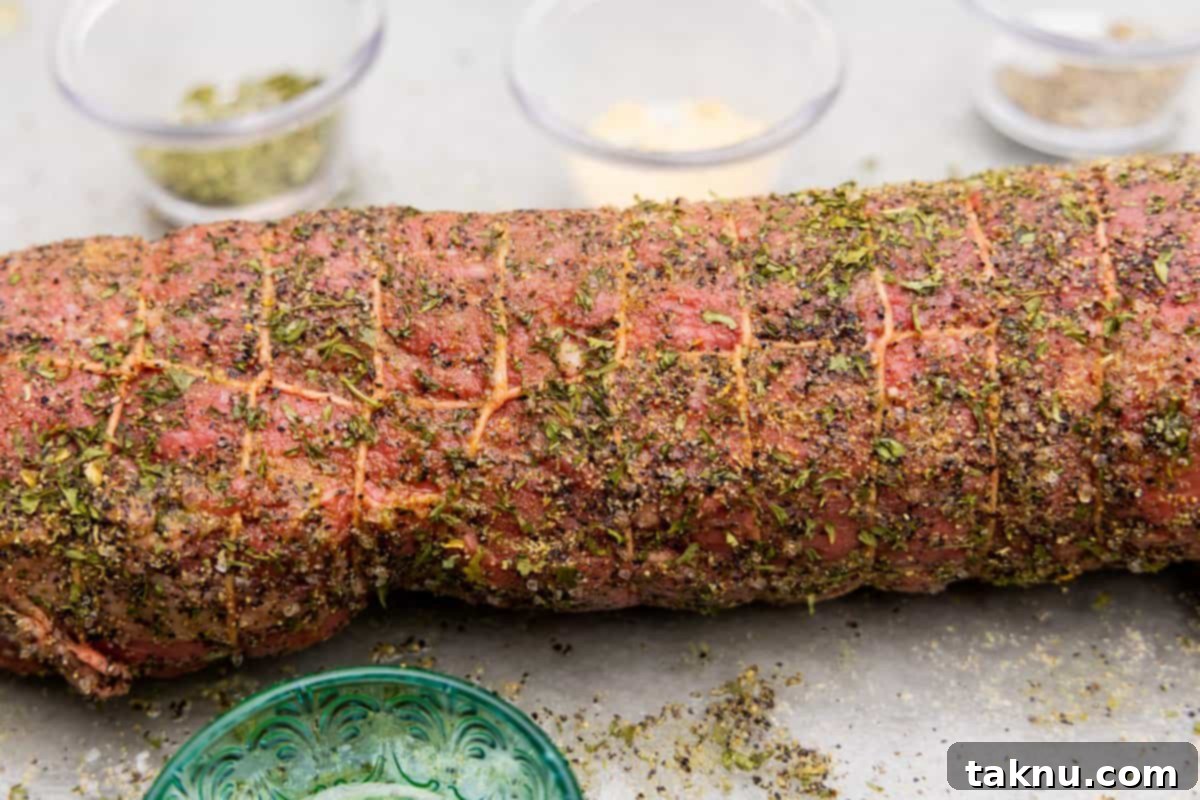 Beef tenderloin trussed with butcher twine and seasoned with spices