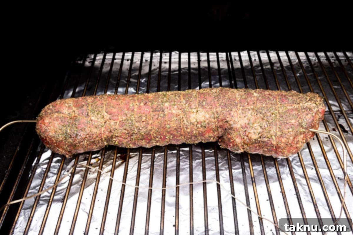 Meat on grill with temperature probes in each end of meat.