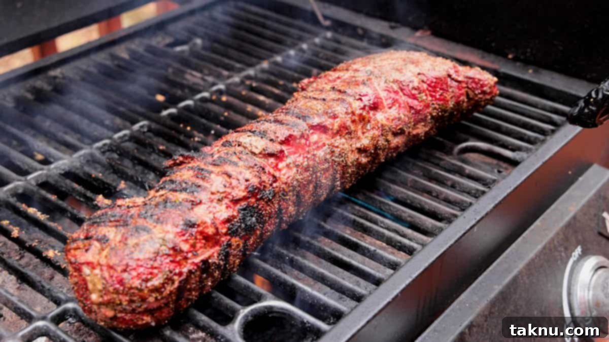 Beef searing on hot grill grates.