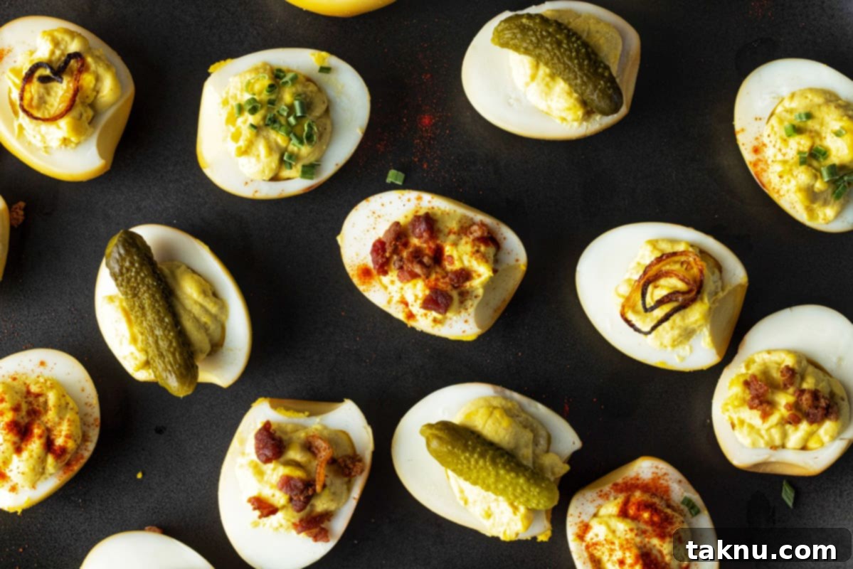 Smoky Deviled Delights 4 Deviled eggs on black platter with pickles, bacon, shallots, and paprika garnish.