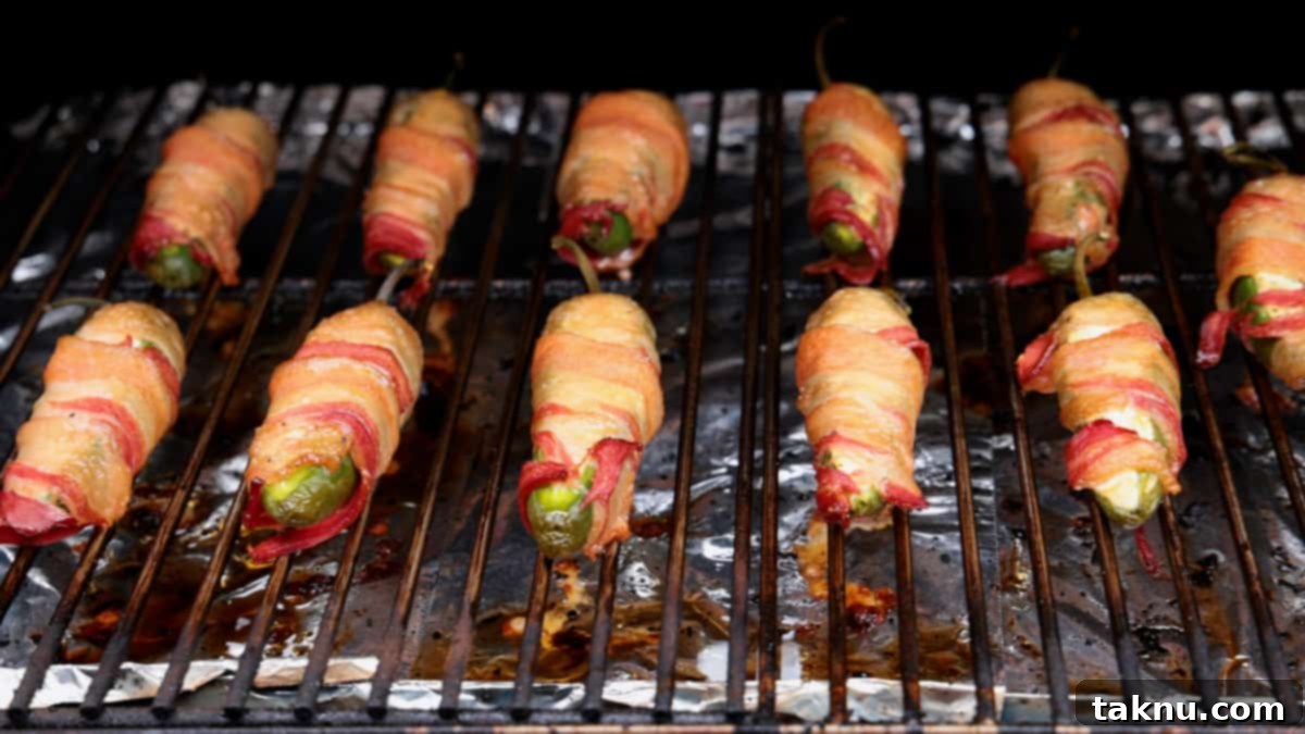 Fiery Smoked Jalapeño Bites 5 A dozen bacon wrapped jalapeno poppers on grill cooking.