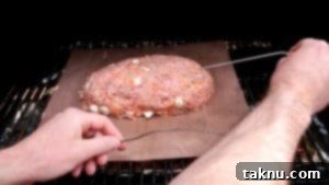 Meatloaf on a grill grate, ready to be placed in the smoker.