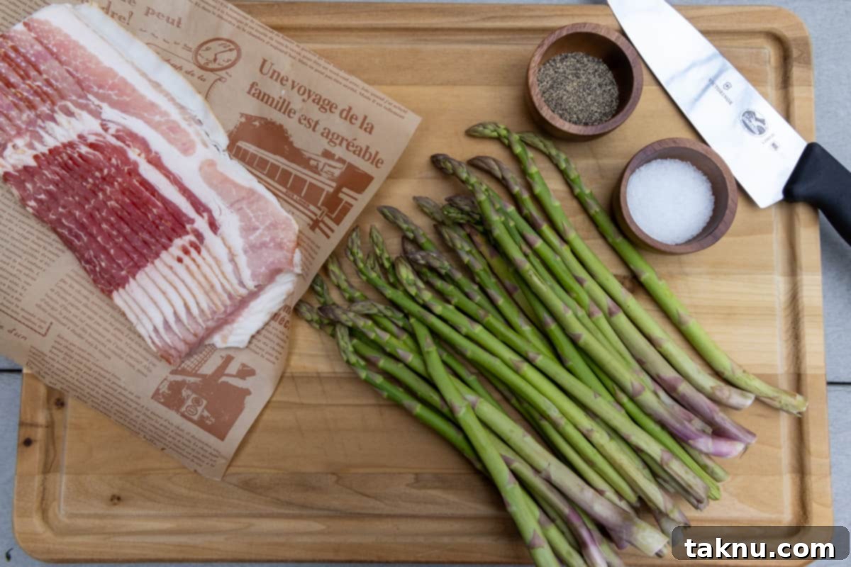 Smoked Bacon Wrapped Asparagus 3 Asparagus, salt, black pepper, bacon, and a knife on a wood cutting board.