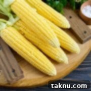 Sizzling Christmas BBQ Recipes 15 Corn on wood board with husks tied back