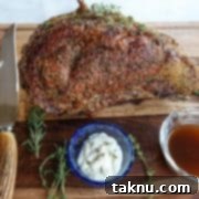 Sizzling Christmas BBQ Recipes 3 Prime rib on cutting board with horseradish, au jus, and knife & fork