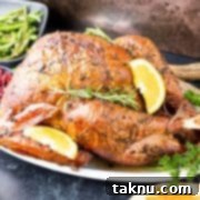 Sizzling Christmas BBQ Recipes 6 Smoked whole turkey on white platter with side dishes around plate.