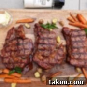 Sizzling Christmas BBQ Recipes 7 Three ribeye steaks cooked on cutting board with carrots and potatoes