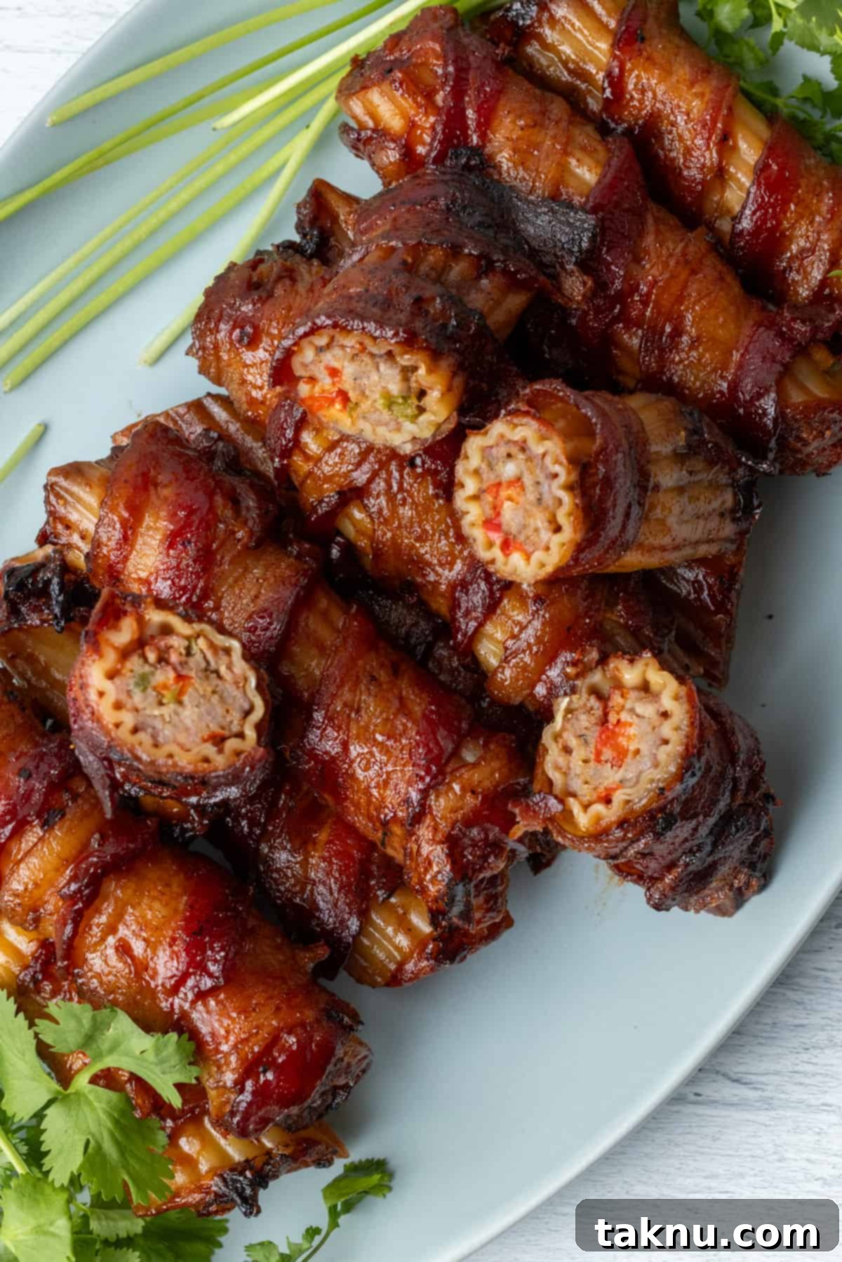 Smoked Barrel Rolls 2 Smoked shotgun shells on white plate with several cut in half, showcasing the delicious filling.