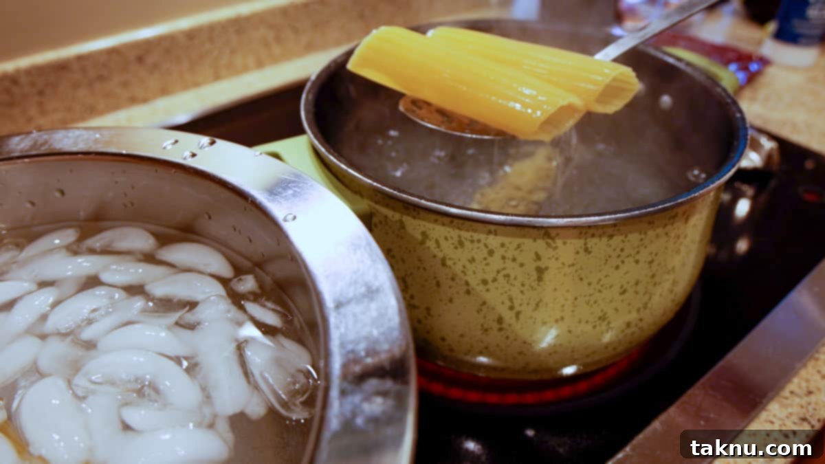 Smoked Barrel Rolls 4 Spooning out of boiling water two manicotti shells with a bowl of ice water next to boiling pot.