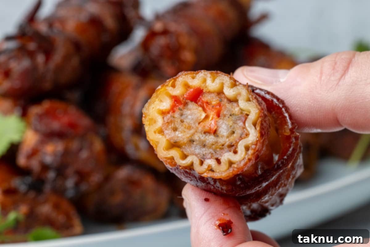 Smoked Barrel Rolls 10 Two fingers holding a stuffed pasta shotgun shell up close showing the meat filling.