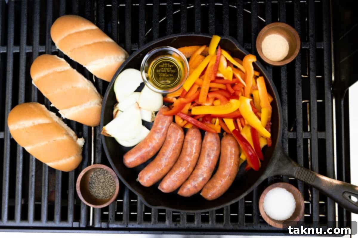 Savory Sausage and Roasted Peppers 3 Sausages, sliced onions & peppers, buns, and salt, pepper, garlic in small dishes on a grill.