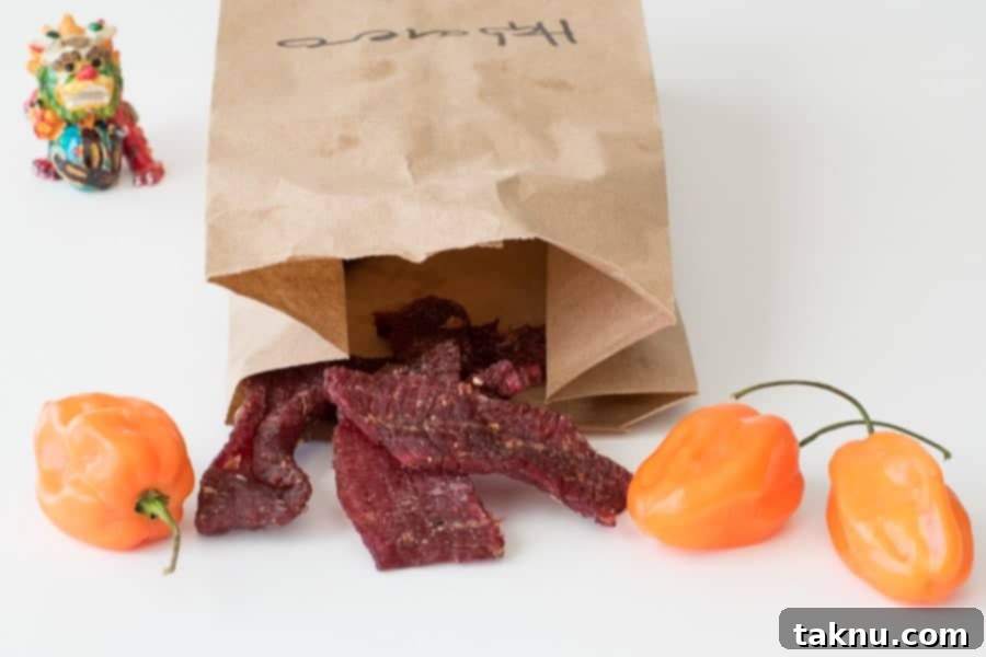 Crafting the Perfect Beef Jerky Marinade 12 Beef jerky in brown bag with three habanero peppers