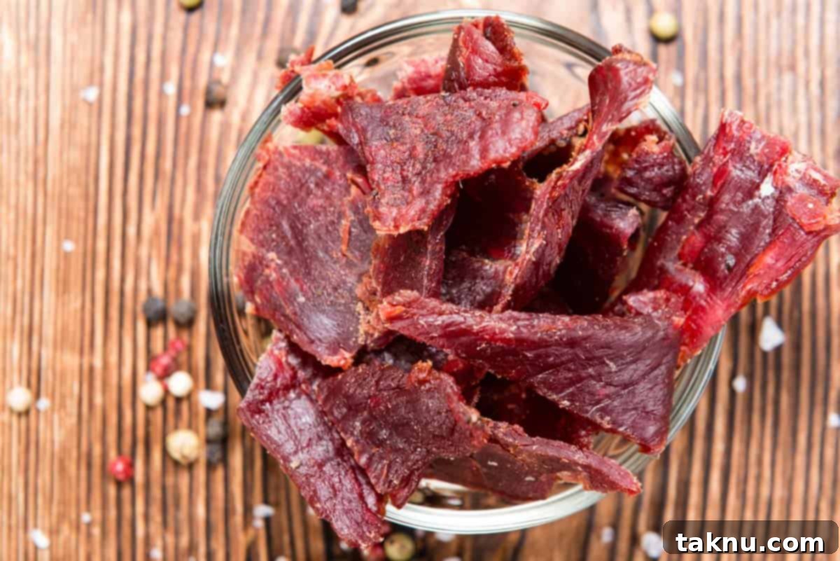 Crafting the Perfect Beef Jerky Marinade 13 Beef jerky in a dish on cutting board with spices scattered around