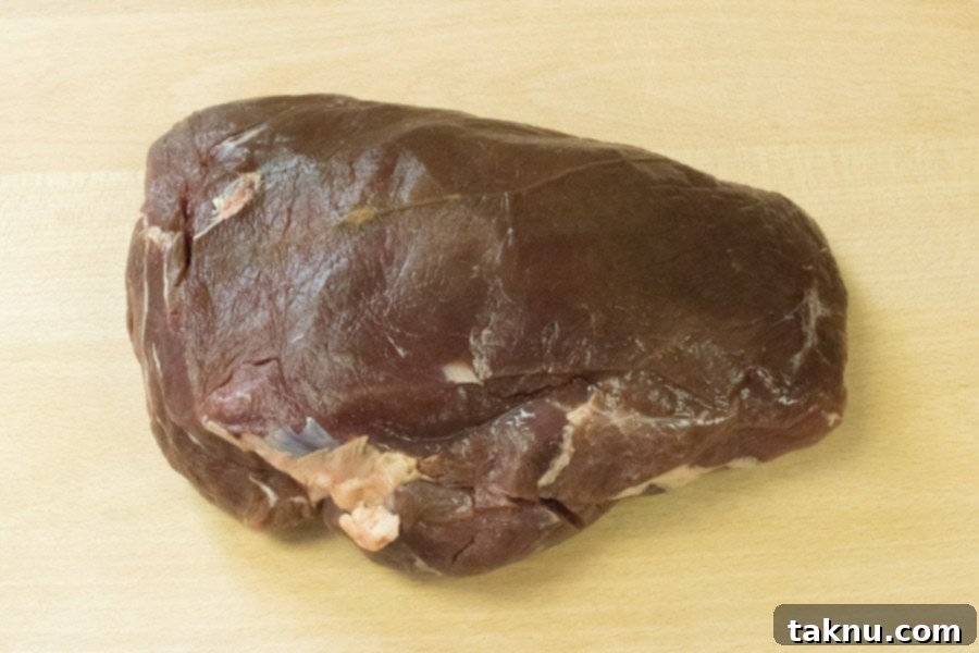 Reaper's Harvest Elk Jerky 2 Lean elk roast ready for jerky preparation on a wooden cutting board