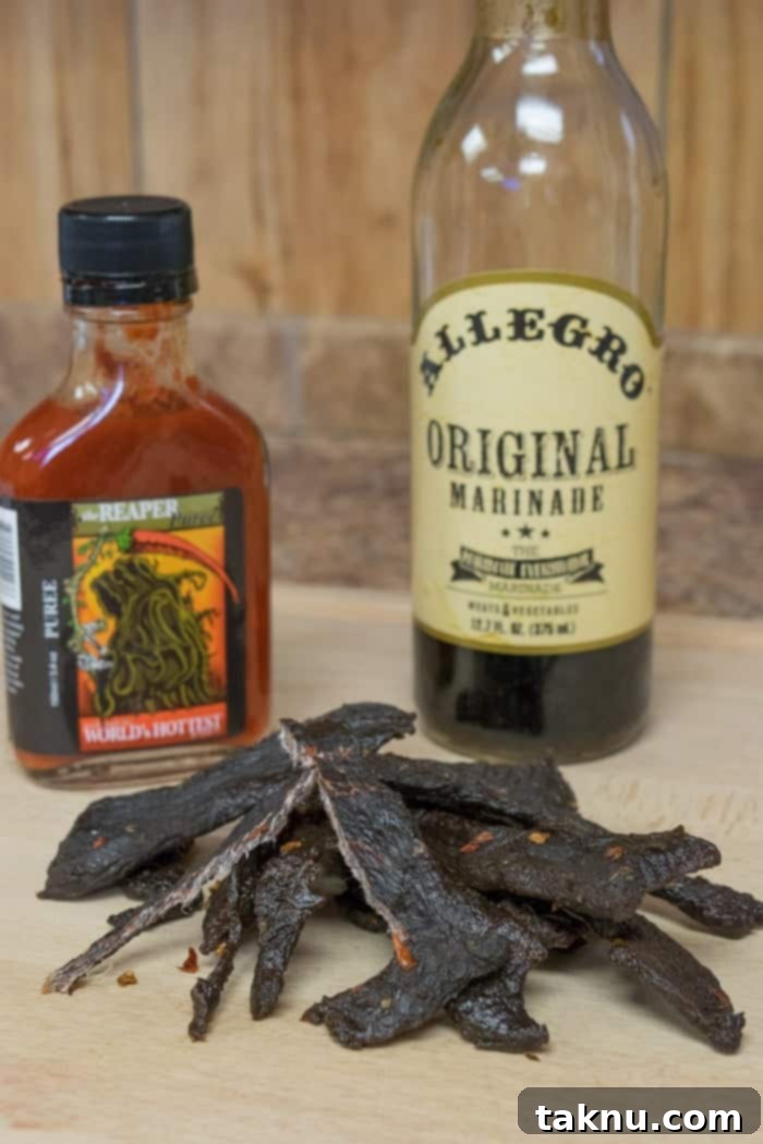 Reaper's Harvest Elk Jerky 7 Finished Grim Reaper Elk Jerky displayed with Carolina Reaper puree and Allegro marinade ingredients