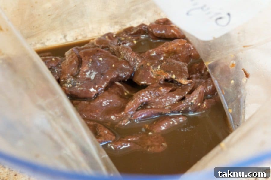 Elk Bugle Jerky 5 Elk jerky strips marinating in a bowl