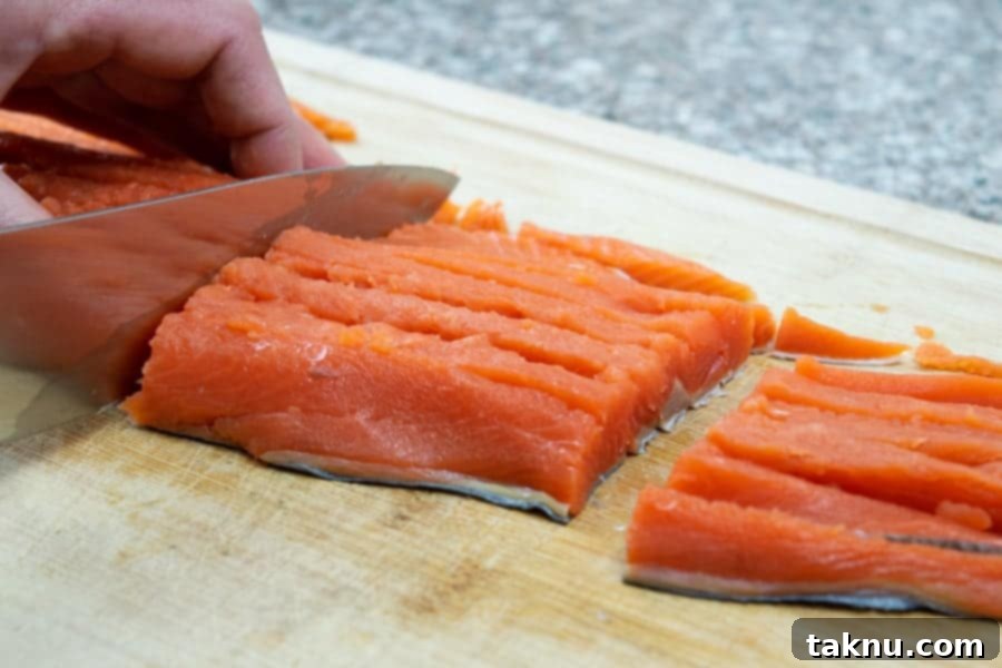 Wild sockeye salmon fillet cut into small strips, ready for jerky marinade