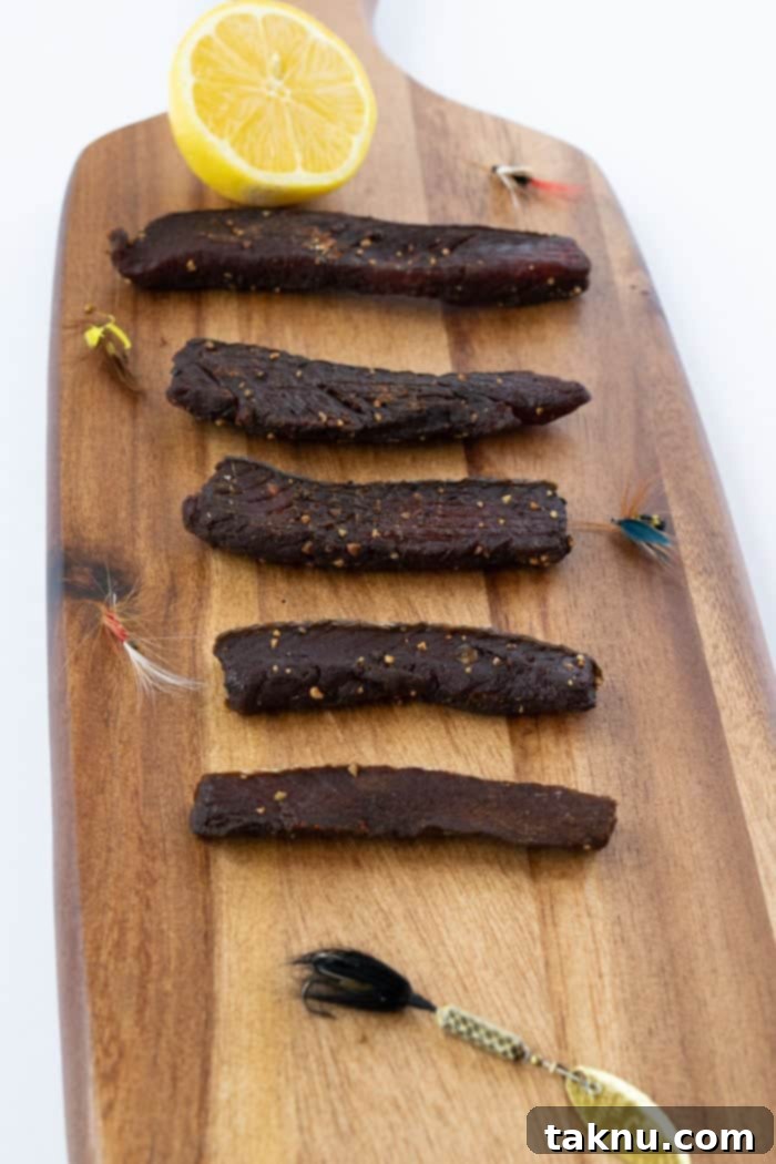 Finished salmon jerky displayed on a wooden cutting board