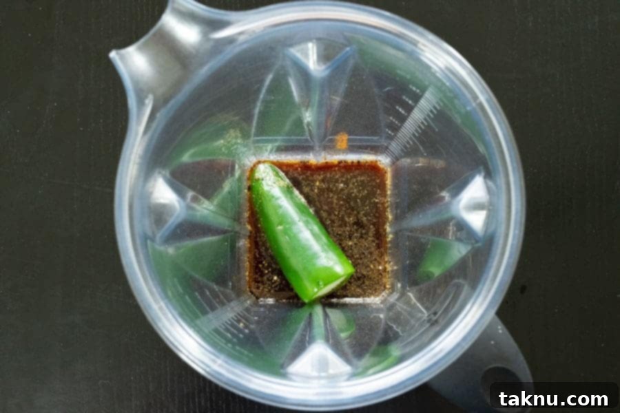 Prepared jalapeño and other marinade ingredients being added to a high-speed blender, ready for processing