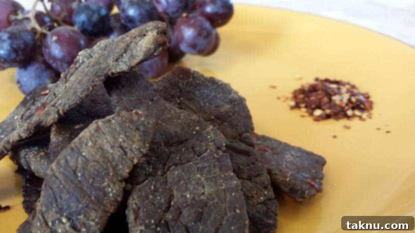 Close-up of perfectly smoked Alton Brown inspired beef jerky slices.