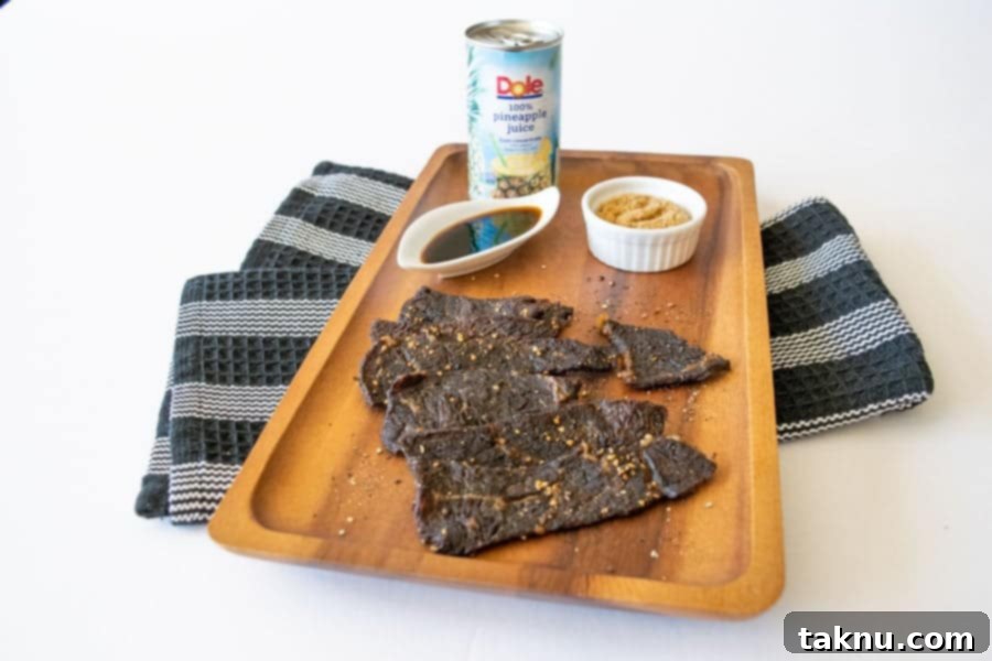 Finished Tropic Thunder beef jerky strips, perfectly dried and ready to eat, on a cutting board