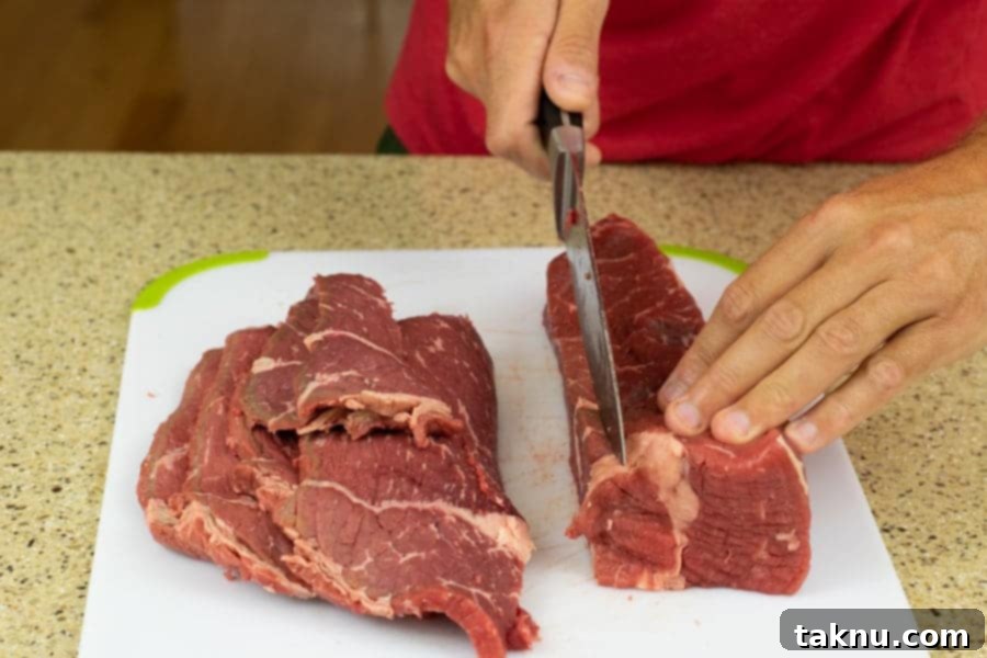 Kikkoman Glazed Teriyaki Beef Jerky 5 Slicing Beef Bottom Round for jerky on cutting board