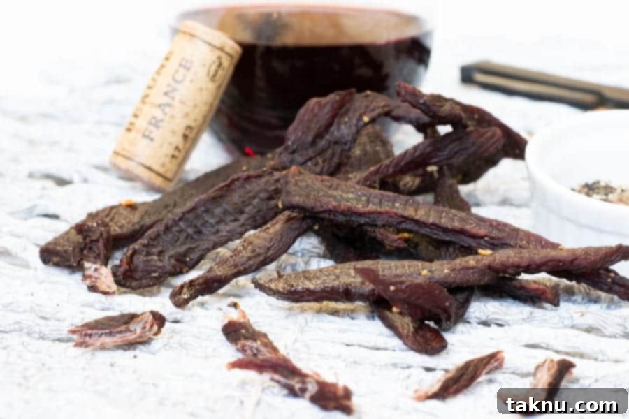 Twisted Venison Jerky 12 Corkscrew deer jerky with cork and wine close up