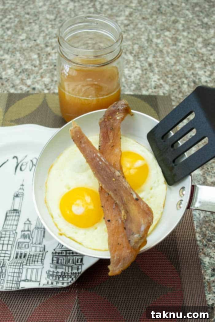 apple sage jerky on frying pan with eggs and apple juice