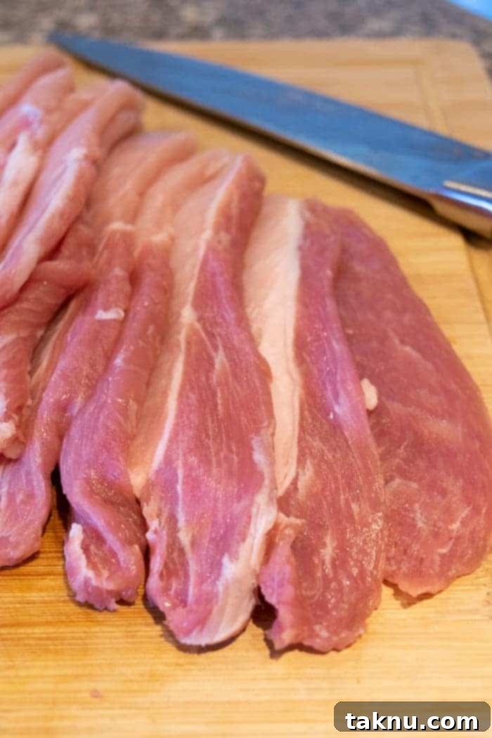 Pork Loin Sliced for jerky on cutting board with knife