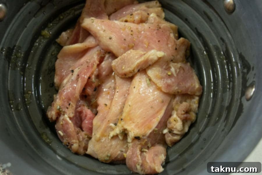 Apple sage pork jerky straining in colander