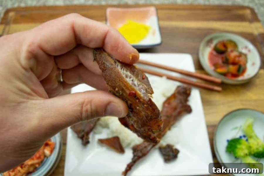 korean bbq pork jerky bent showing white fibers of meat