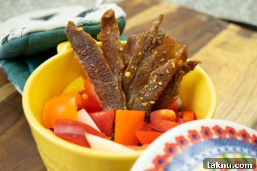 Italian Pork Jerky in dish with peppers and onions