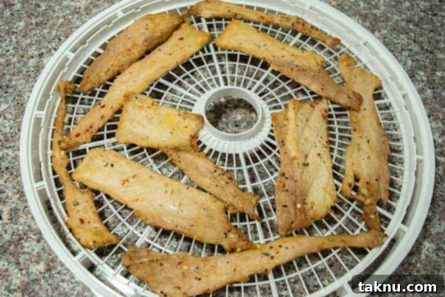 italian pork jerky on dehydrator tray