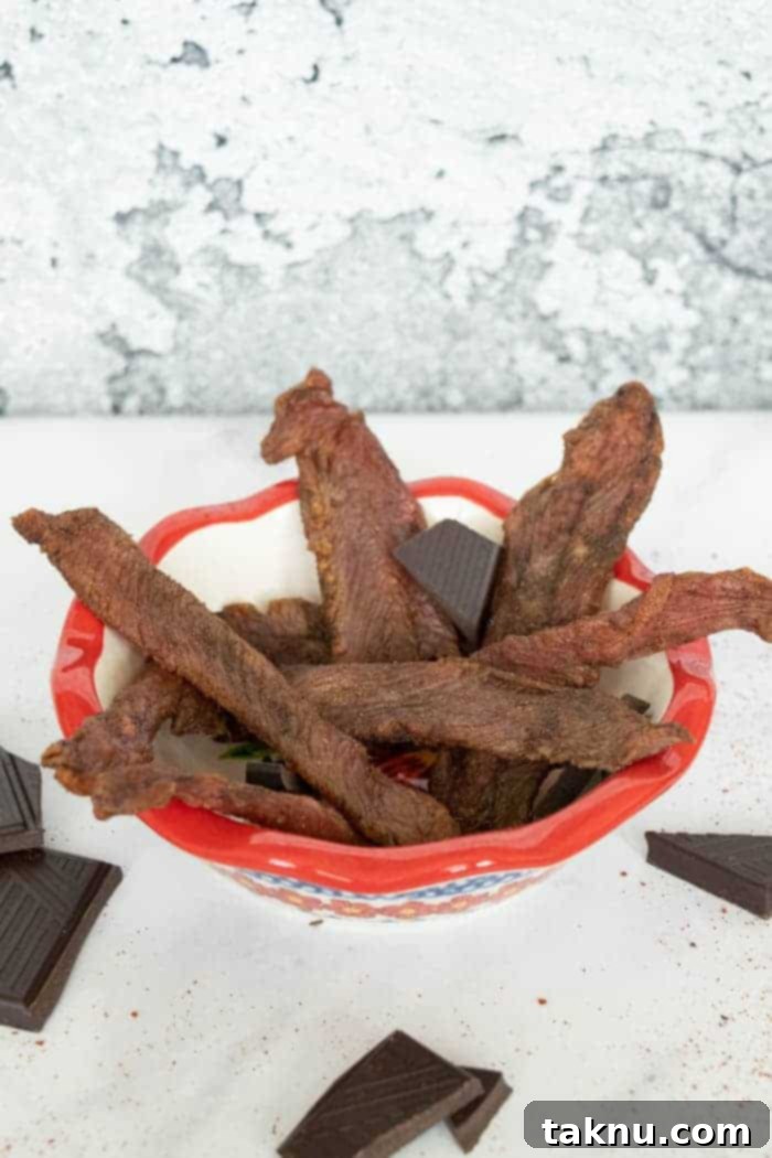 Indulgent Mole Turkey Jerky 2 Mole turkey jerky in bowl with chocolate