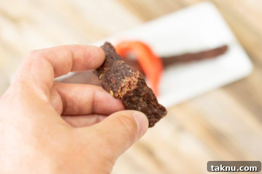 Bending jerky strip to see if it is finished 