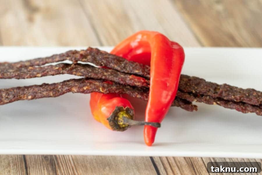 Fiery ground beef jerky wrapped in banana pepper on plate