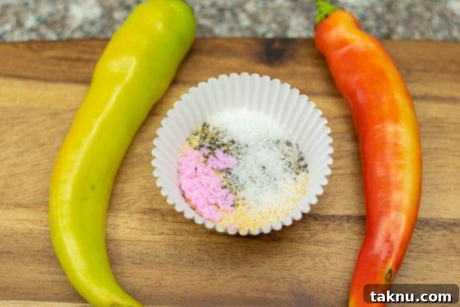 Ingredients for spicy jerky in dish with two banana peppers surrounding it on a cutting board